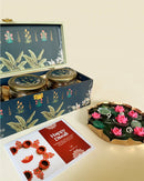 Diwali gift hamper with masala dry fruits, besan laddoo, and soan papdi in festive jars