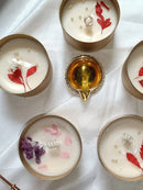 Candle holders with floral designs on a white surface