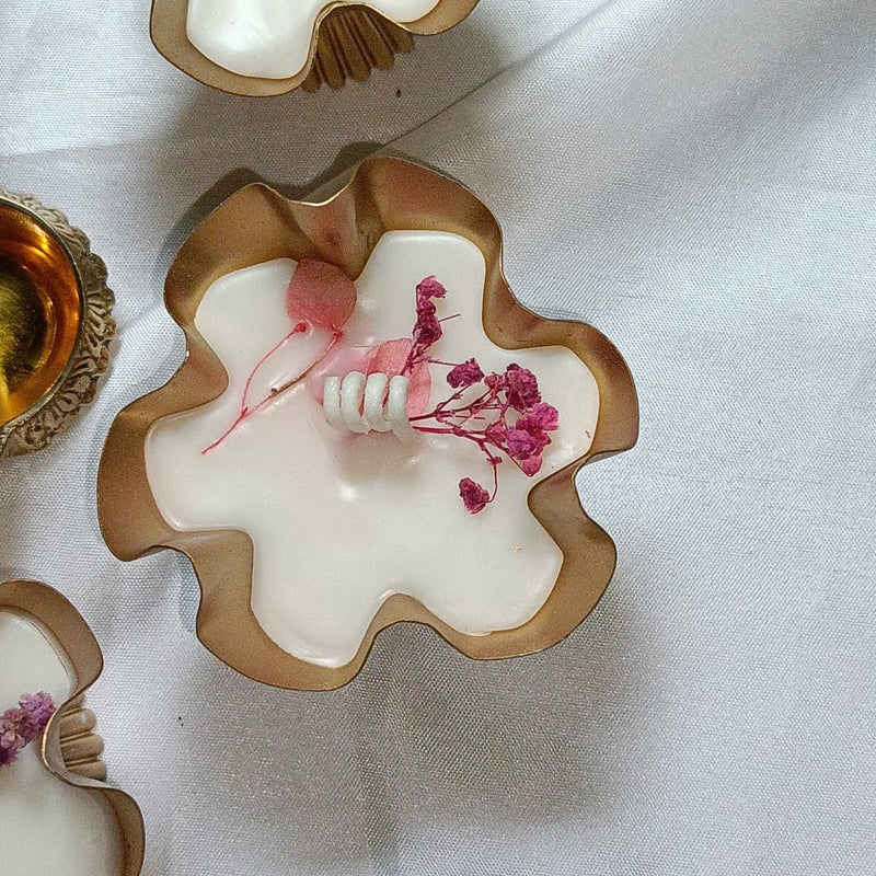 Decorative ceramic bowls with floral elements on a white fabric background